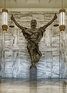 Photo of a statue of Lady Justice holding up the scales of justice.